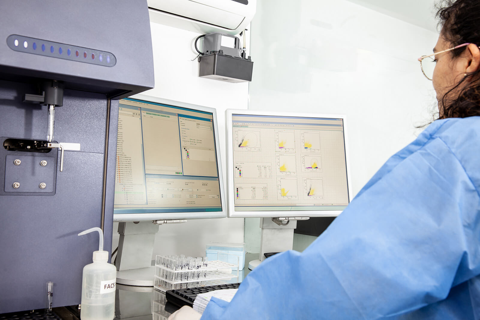 Female scientist in a lab analysing lateral flows on a computer